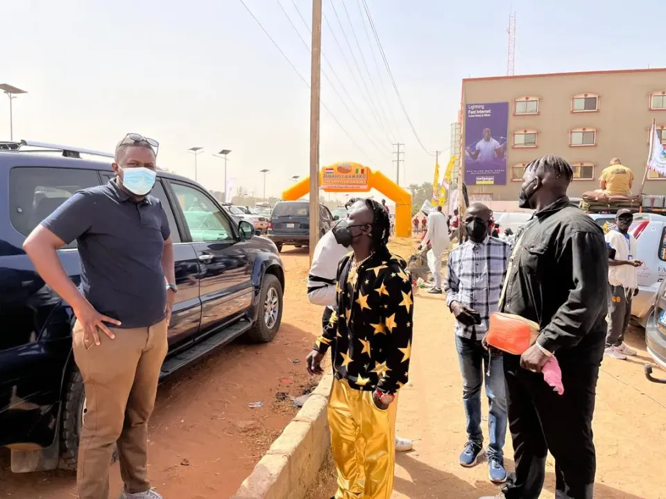 Rally vehicles crossing the official Budapest–Bamako 2025 finish line during the closing event in Senegambia.