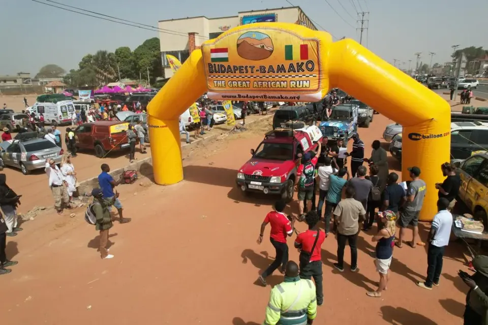Rally vehicles crossing the official Budapest–Bamako 2025 finish line during the closing event in Senegambia.